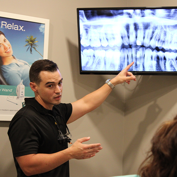 Doctor Perez showing a patient their dental x rays
